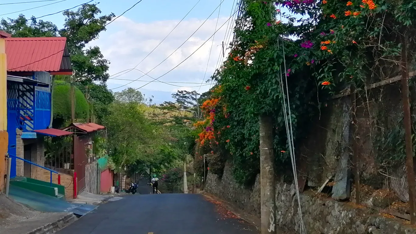 small street on costa rica, with a wall with a climbing wall