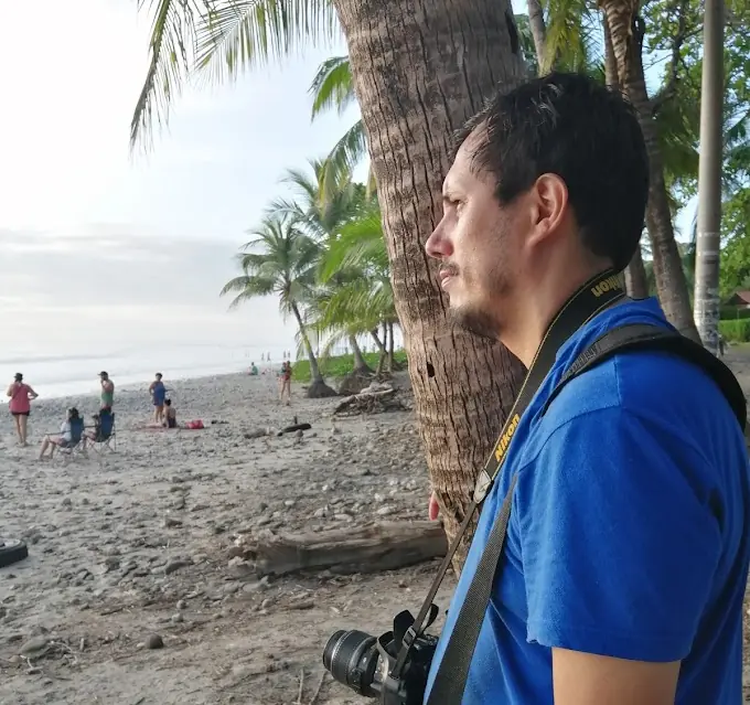 man watching the sunset at beach