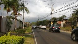 View of a costa rican street with cars, mostly SUVs