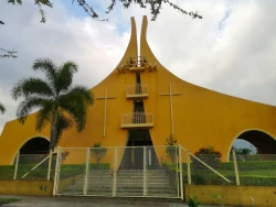 A view of a yellow painted catholic church