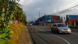 Street in Costa Rica, with a sidewalk and transport containers